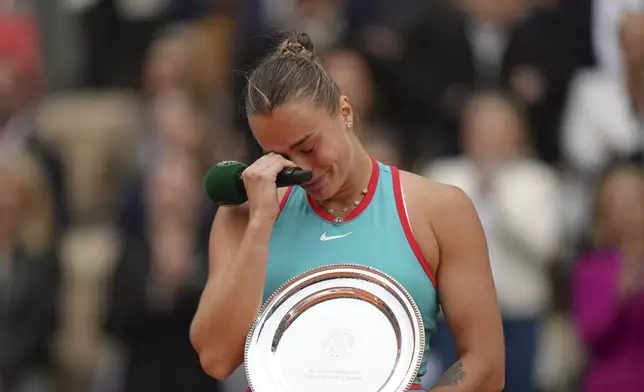Second placed Aryna Sabalenka of Belarus reacts with the trophy after the final match of the French Tennis Open against Coco Gauff of the U.S. at the Roland-Garros stadium in Paris, Saturday, June 7, 2025. (AP Photo/Aurelien Morissard)