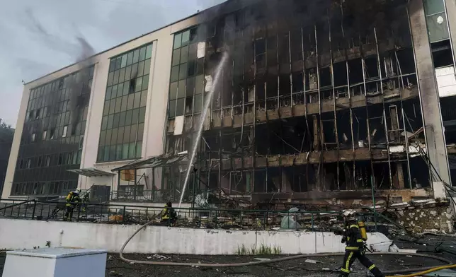 FILE - Rescue workers put out a fire of a building damaged by a Russian drone strike on Kyiv, Ukraine, Tuesday, June 10, 2025. (AP Photo/Evgeniy Maloletka, File)
