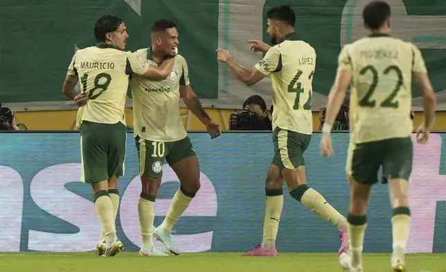 Palmeiras' Mauricio, left, celebrates after scoring his side's second goal during the Club World Cup Group A soccer match between Inter Miami and Palmeiras in Miami Gardens, Fla., Monday, June 23, 2025. (AP Photo/Lynne Sladky)