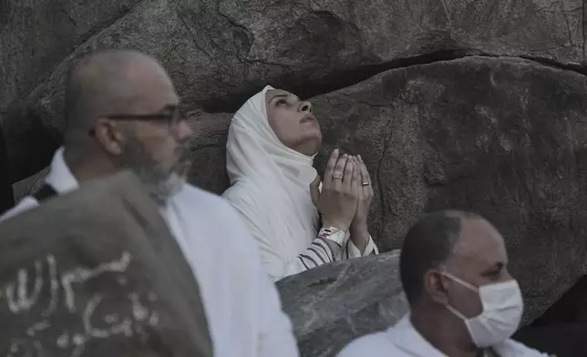 Muslim pilgrims offer prayers at top of the rocky hill known as the Mountain of Mercy, on the Plain of Arafat, during the annual Hajj pilgrimage near the holy city of Mecca, Saudi Arabia, Thursday, June 5, 2025. (AP Photo/Amr Nabil)