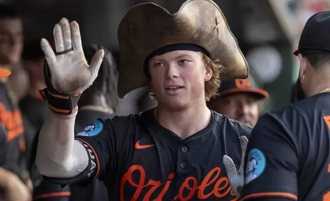 Baltimore Orioles' Jackson Holliday celebrates in the dugout after a solo home run during the fifth inning of a baseball game against the Athletics Friday, June 6, 2025, in West Sacramento, Calif. (AP Photo/Sara Nevis)