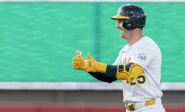 Athletics' Brent Rooker gives a thumbs up to the dugout after hitting a double during the third inning of a baseball game against the Baltimore Orioles Friday, June 6, 2025, in West Sacramento, Calif. (AP Photo/Sara Nevis)