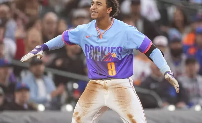 Colorado Rockies' Ryan Ritter reacts after reaching third base with a triple off New York Mets starting pitcher Kodai Senga in the fifth inning of a baseball game Friday, June 6, 2025, in Denver. (AP Photo/David Zalubowski)