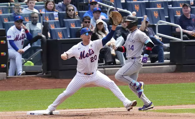 Colorado Rockies' Ezequiel Tovar, right, can't beat the throw to New York Mets first baseman Pete Alonso during the first inning of a baseball game, Sunday, June 1, 2025, in New York. (AP Photo/Seth Wenig)