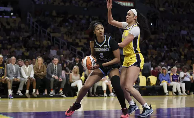 Chicago Sky forward Angel Reese, left, dribbles against Los Angeles Sparks forward Dearica Hamby, right, during the first half of a WNBA basketball game, Sunday, June 29, 2025, in Los Angeles. (AP Photo/Jessie Alcheh)