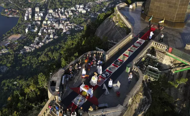 Rugs made from plastic bottle caps line the walkway to the Christ the Redeemer statue during a Mass celebrating the Catholic holiday of Corpus Christi in Rio de Janeiro, Thursday, June 19, 2025. (AP Photo/Bruna Prado)
