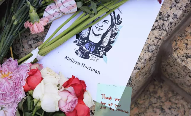 People attend a candlelight vigil for former House Speaker Melissa Hortman and her husband Mark, who were fatally shot, at the state Capitol, Wednesday, June 18, 2025, in St. Paul, Minn. (AP Photo/Nikolas Liepins)
