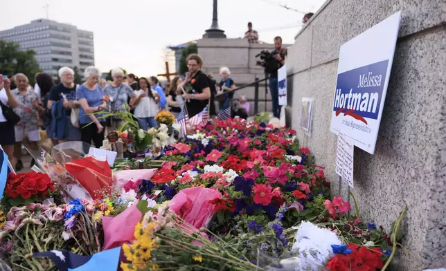 People attend a candlelight vigil for former House Speaker Melissa Hortman and her husband Mark, who were fatally shot, at the state Capitol, Wednesday, June 18, 2025, in St. Paul, Minn. (AP Photo/Nikolas Liepins)