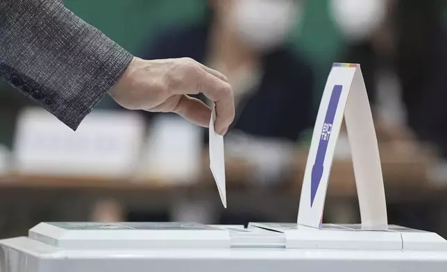 A man casts his vote for the presidential election at a polling station in Seoul, South Korea, Tuesday, June 3, 2025. (AP Photo/Lee Jin-man)
