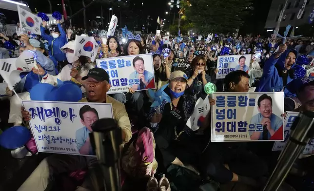 Supporters of South Korea's Democratic Party's presidential candidate Lee Jae-myung, react outside the National Assembly in Seoul, South Korea, Tuesday, June 3, 2025. (AP Photo/Ahn Young-joon)