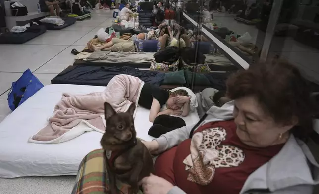 People take shelter in an underground metro station as a precaution against possible Iran missile attacks, in Ramat Gan, near Tel Aviv, Israel, Tuesday, June 17, 2025. (AP Photo/Oded Balilty)