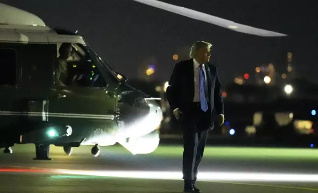 President Donald Trump walks from Marine One to board Air Force One at Calgary International Airport, Monday, June 16, 2025, in Calgary, Canada, on his way back to Washington. (AP Photo/Mark Schiefelbein)