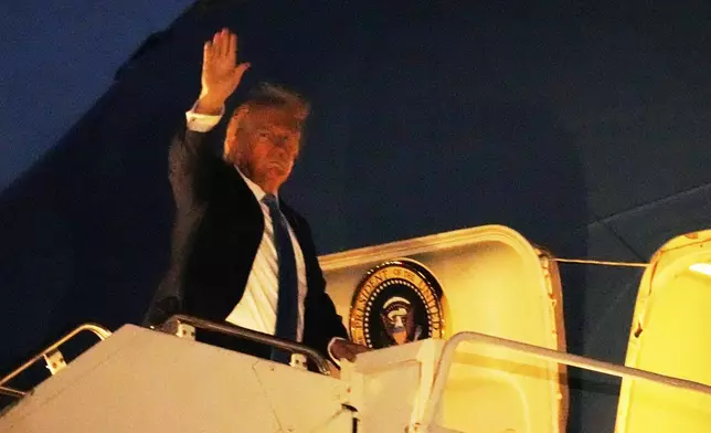 President Donald Trump boards Air Force One at Calgary International Airport, Monday, June 16, 2025, in Calgary, Canada, on his way back to Washington. (AP Photo/Mark Schiefelbein)