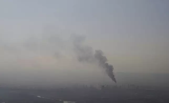 Smoke billows after an Iranian missile struck an oil refinery in Haifa, northern Israel, early Monday, June 16, 2025. (AP Photo/Ariel Schalit)