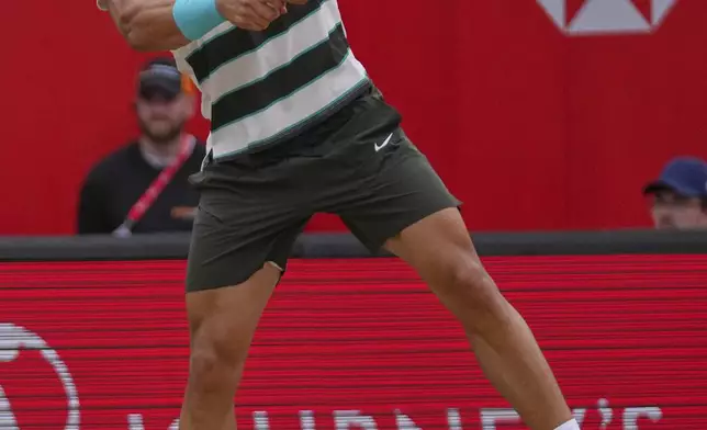 Carlos Alcaraz of Spain leaps as he plays a return to Jiri Lehecka of the Czech Republic, during the men's singles final of the Queens Club tennis championships in London, Sunday, June 22, 2025. (AP Photo/Joanna Chan)