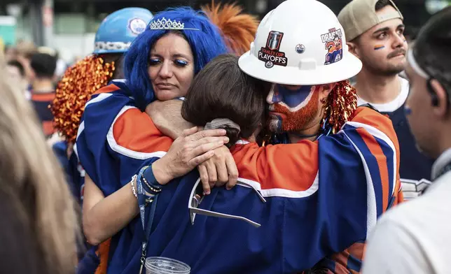Fans react to the Edmonton Oilers losing to the Florida Panthers in Game 6 of the NHL hockey Stanley Cup Final during an outdoor viewing party in Edmonton, Alberta, Tuesday, June 17, 2025. (Jason Franson/The Canadian Press via AP)