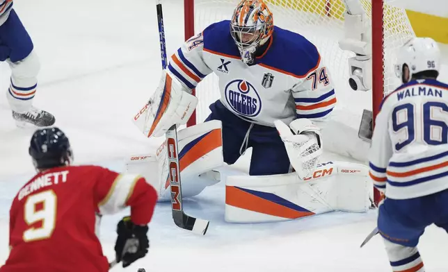 Edmonton Oilers goalie Stuart Skinner (74) stops Florida Panthers' Sam Bennett (9) during the second period in Game 6 of the NHL hockey Stanley Cup Final in Sunrise, Fla., Tuesday, June 17, 2025. (Nathan Denette/The Canadian Press via AP)
