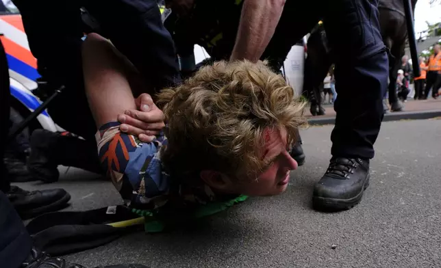 Police detain a protester during a rally against the NATO summit in The Hague, Netherlands, Wednesday, June 25, 2025. (AP Photo/Patrick Post)
