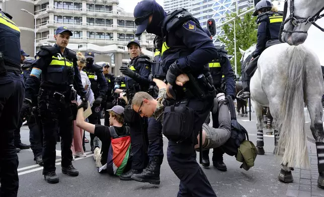 Police detain protesters during a rally against the NATO summit in The Hague, Netherlands, Wednesday, June 25, 2025. (AP Photo/Patrick Post)