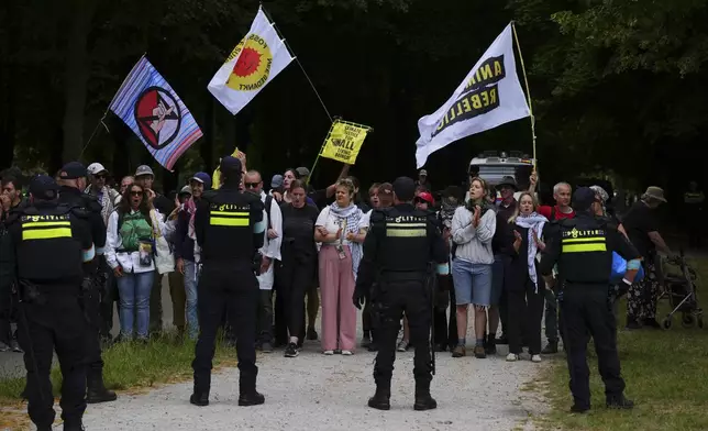Demonstrators protest against the NATO summit as police block a road in The Hague, Netherlands, Wednesday, June 25, 2025. (AP Photo/Peter Dejong)