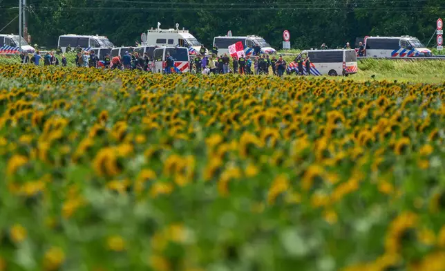 Demonstrators with Extinction Rebellion attempted to block the A44 motorway, closed off to all traffic except for arriving and departing world leaders, in Abbenes, Netherlands, Monday, June 23, 2025, for the NATO summit in The Hague. (AP Photo/Peter Dejong)