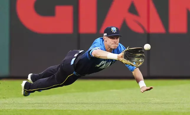 Philadelphia Phillies' Max Kepler makes a diving catch on a ball hit by Toronto Blue Jays' Myles Straw during the second inning of a baseball game Friday, June 13, 2025, in Philadelphia. (AP Photo/Derik Hamilton)