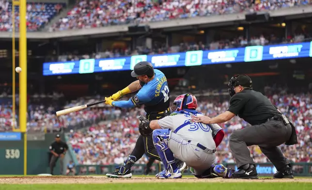 Philadelphia Phillies' Kyle Schwarber (12) hits a three-run home run off Toronto Blue Jays pitcher Kevin Gausman during the second inning of a baseball game, Friday, June 13, 2025, in Philadelphia. (AP Photo/Derik Hamilton)