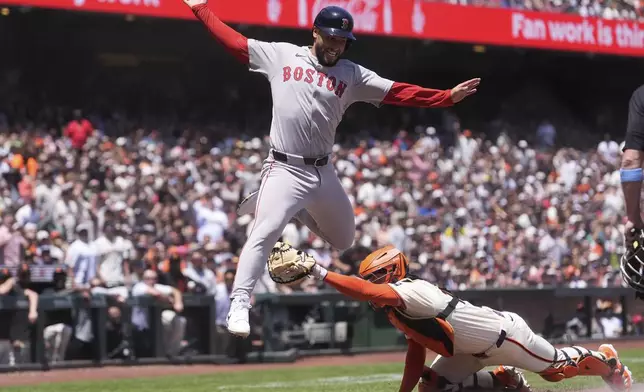 Boston Red Sox's Abraham Toro, left, is called out at home as San Francisco Giants catcher Patrick Bailey reaches for him during the fourth inning of a baseball game in San Francisco, Sunday, June 22, 2025. (AP Photo/Jeff Chiu)