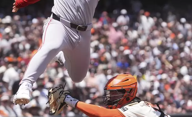 Boston Red Sox's Abraham Toro, left, is called out at home as San Francisco Giants catcher Patrick Bailey reaches for him during the fourth inning of a baseball game in San Francisco, Sunday, June 22, 2025. (AP Photo/Jeff Chiu)