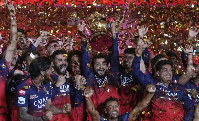 Royal Challengers Bengaluru players celebrate with the winners trophy after their win in the Indian Premier League final cricket match against Punjab Kings at Narendra Modi Stadium in Ahmedabad, India, Wednesday, June 4, 2025. (AP Photo/Ajit Solanki)