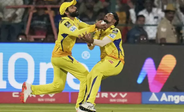 Chennai Super Kings' Ravindra Jadeja, left, and teammate Matheesha Pathirana collide as they run to catch the ball during the Indian Premier League cricket match against Royal Challengers Bengaluru in Bengaluru, India, Saturday, May 3, 2025. (AP Photo/Aijaz Rahi)