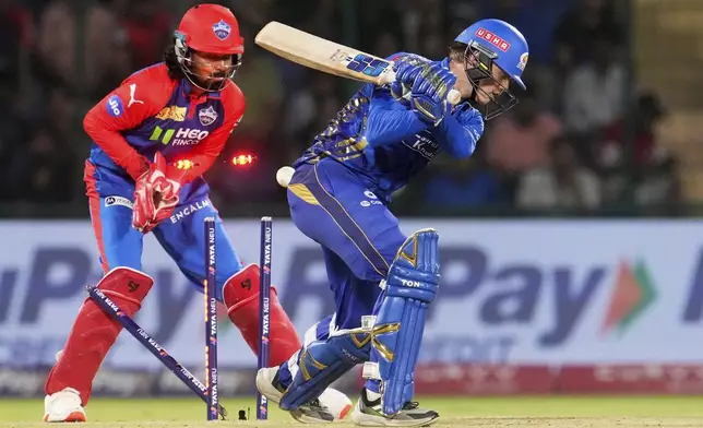 Mumbai Indians' Ryan Rickelton is bowled out by Delhi Capitals' Kuldeep Yadav during their Indian Premier League cricket match in New Delhi, India, Sunday, April 13, 2025. (AP Photo/Manish Swarup)