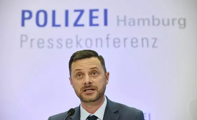 Florian Abbenseth, police press spokesman, speaks at a press conference by the police and Chief Public Prosecutor at police headquarters after a 20-year-old was arrested on suspicion of murdering a child, in Hamburg, Germany, Wednesday, June 18, 2025. (Georg Wendt/dpa via AP)