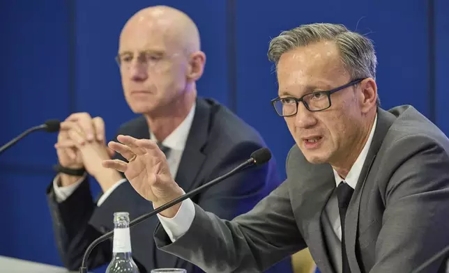 Chief Public Prosecutor Joerg Froehlich, left, and Chief of Police Falk Schnabel give a press conference by the police and Chief Public Prosecutor at police headquarters after a 20-year-old was arrested on suspicion of murdering a child, in Hamburg, Germany, Wednesday, June 18, 2025. (Georg Wendt/dpa via AP)