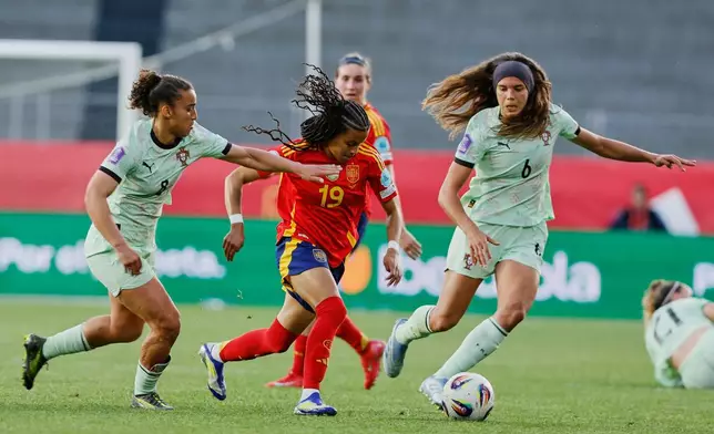 FILE - Spain's Vicky Lopez, centre, challenges for the ball with Portugal's Andreia Norton, left, and Portugal's Andreia Jacinto during the Women's Nations League Group A3 soccer match between Spain and Portugal at the Balaidos stadium in Vigo, Spain, Tuesday, April 8, 2025. (AP Photo/Lalo Villar, File)