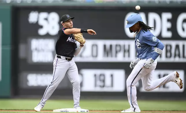 Washington Nationals' CJ Abrams, right, is forced out at second base as Miami Marlins second baseman Javier Sanoja, left, throws to first base to put out Nationals' Amed Rosario for a double-play during the first inning of a baseball game, Saturday, June 14, 2025, in Washington. (AP Photo/Nick Wass)