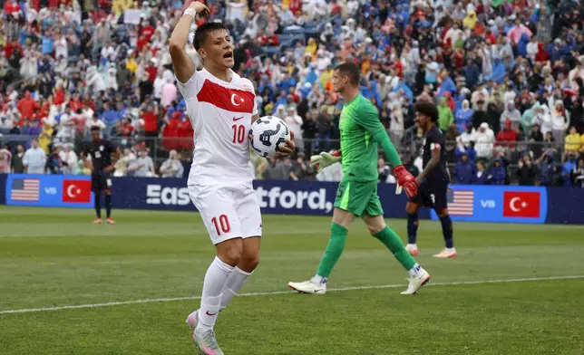 Turkey forward Arda Güler (10) reacts after scoring a goal past United States goalie Matt Freese (25) during the first half of an international friendly soccer game, Saturday, June 7, 2025, in East Hartford, Conn. (AP Photo/Mary Schwalm)