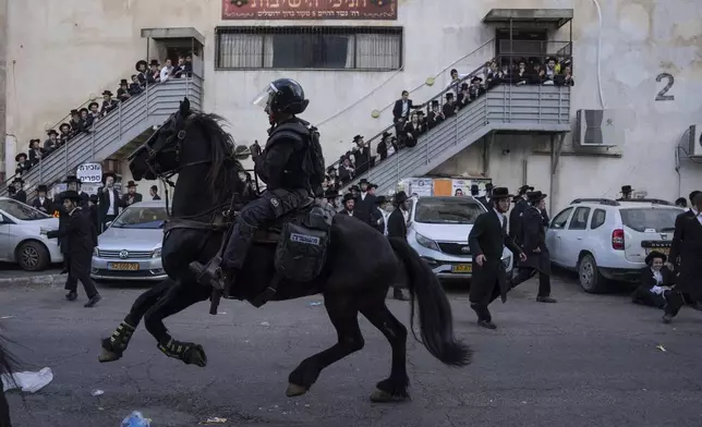 FILE - Israeli police officers scuffle with ultra-Orthodox Jewish men during a protest against a potential new draft law in Jerusalem, Oct. 31, 2024. (AP Photo/Ohad Zwigenberg, File)