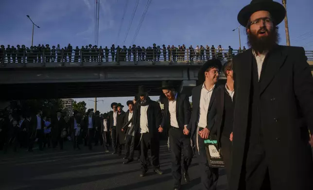 FILE - Ultra-Orthodox Jewish men block a highway during a protest against army recruitment in Bnei Brak, Israel, on March 2, 2025. (AP Photo/Ohad Zwigenberg, File)