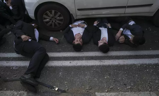 FILE - Ultra-Orthodox Jewish men block a highway during a protest against army recruitment in Bnei Brak, Israel, on March 2, 2025. (AP Photo/Ohad Zwigenberg, File)