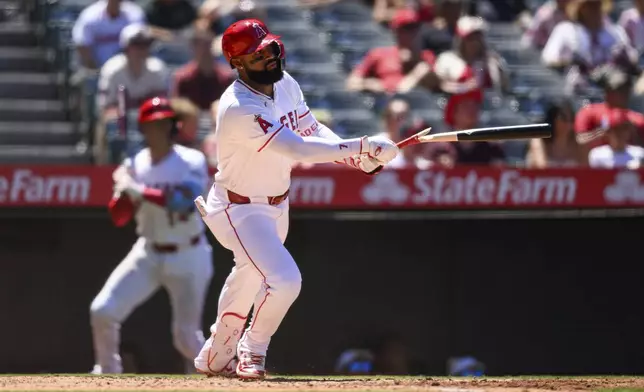 Los Angeles Angels' Jo Adell hits an RBI single to tie the game during the sixth inning of a baseball game against the Washington Nationals, Sunday, June 29, 2025, in Anaheim, Calif. (AP Photo/William Liang)