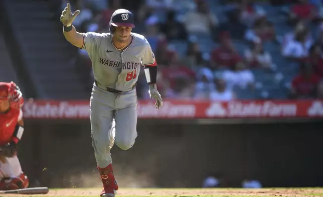 Washington Nationals' Drew Millas gestures after hitting an RBI double during the 11th inning of a baseball game against the Los Angeles Angels, Sunday, June 29, 2025, in Anaheim, Calif. (AP Photo/William Liang)