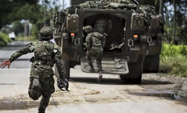 Soldiers patrol after a bomb explosion in Guachinte, Valle del Cauca, Colombia, Tuesday, June 10, 2025. (AP Photo/Santiago Saldarriaga)