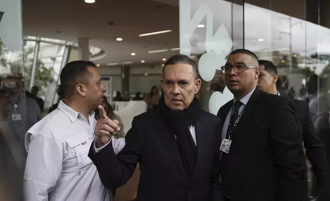 Senate President Efrain Cepeda, center, leaves the clinic where Colombian Senator Miguel Uribe Turbay is being treated after he was shot at a political rally in Bogota, Colombia, Monday, June 9, 2025. (AP Photo/Ivan Valencia)
