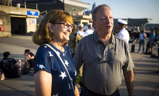 Cindy and Andrew Forrest came to send off their son, surface warfare officer Andrew Forrest, 28, on the USS Gerald R. Ford as the aircraft carrier prepares to leave for deployment from Naval Station Norfolk, Tuesday, June 24, 2025, in Norfolk, Va. (AP Photo/John Clark)
