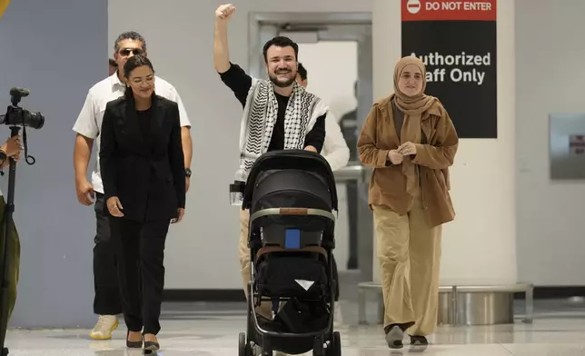Mahmoud Khalil, center, reacts alongside his wife, Noor Abdalla, right, upon arriving at Newark International Airport , Saturday, June 21, 2025, in Newark, N.J. (AP Photo/Seth Wenig)