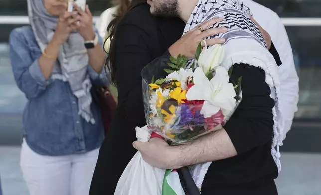 Mahmoud Khalil, right, hugs Rep. Alexandria Ocasio-Cortez, D-N.Y., after arriving at Newark International Airport, Saturday, June 21, 2025, in Newark, N.J. (AP Photo/Seth Wenig)