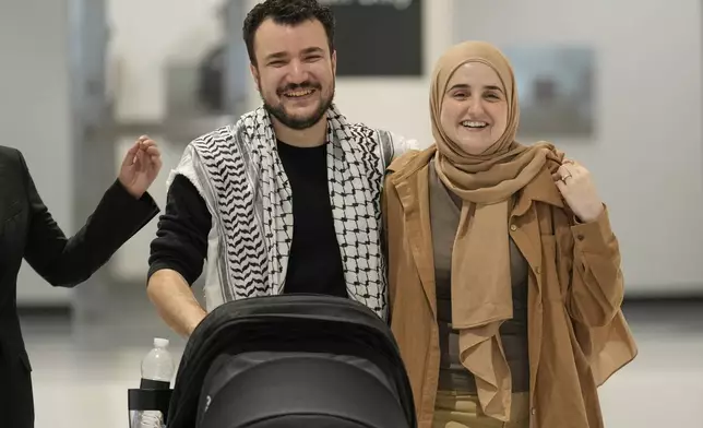 Mahmoud Khalil, left, reacts alongside his wife, Noor Abdalla, right, upon arriving at Newark International Airport, Saturday, June 21, 2025, in Newark, N.J. (AP Photo/Seth Wenig)