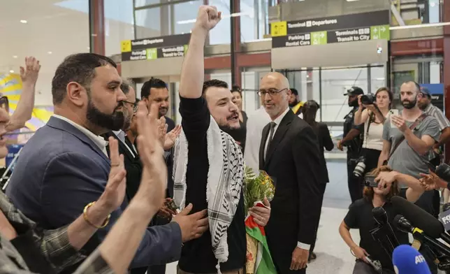 Mahmoud Khalil, center, reacts as he is greeted upon arriving at Newark International Airport, Saturday, June 21, 2025, in Newark, N.J. (AP Photo/Seth Wenig)