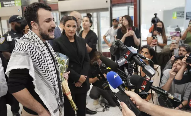 Mahmoud Khalil, left, speaks during a news conference as Rep. Alexandria Ocasio-Cortez, D-N.Y., looks on upon Khalil's arrival at Newark International Airport, Saturday, June 21, 2025, in Newark, N.J. (AP Photo/Seth Wenig)